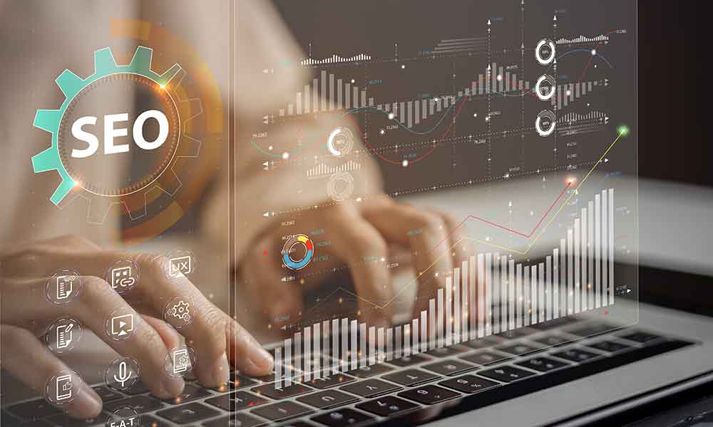 man typing on keyboard and glass monitor with SEO data & graphics lit up